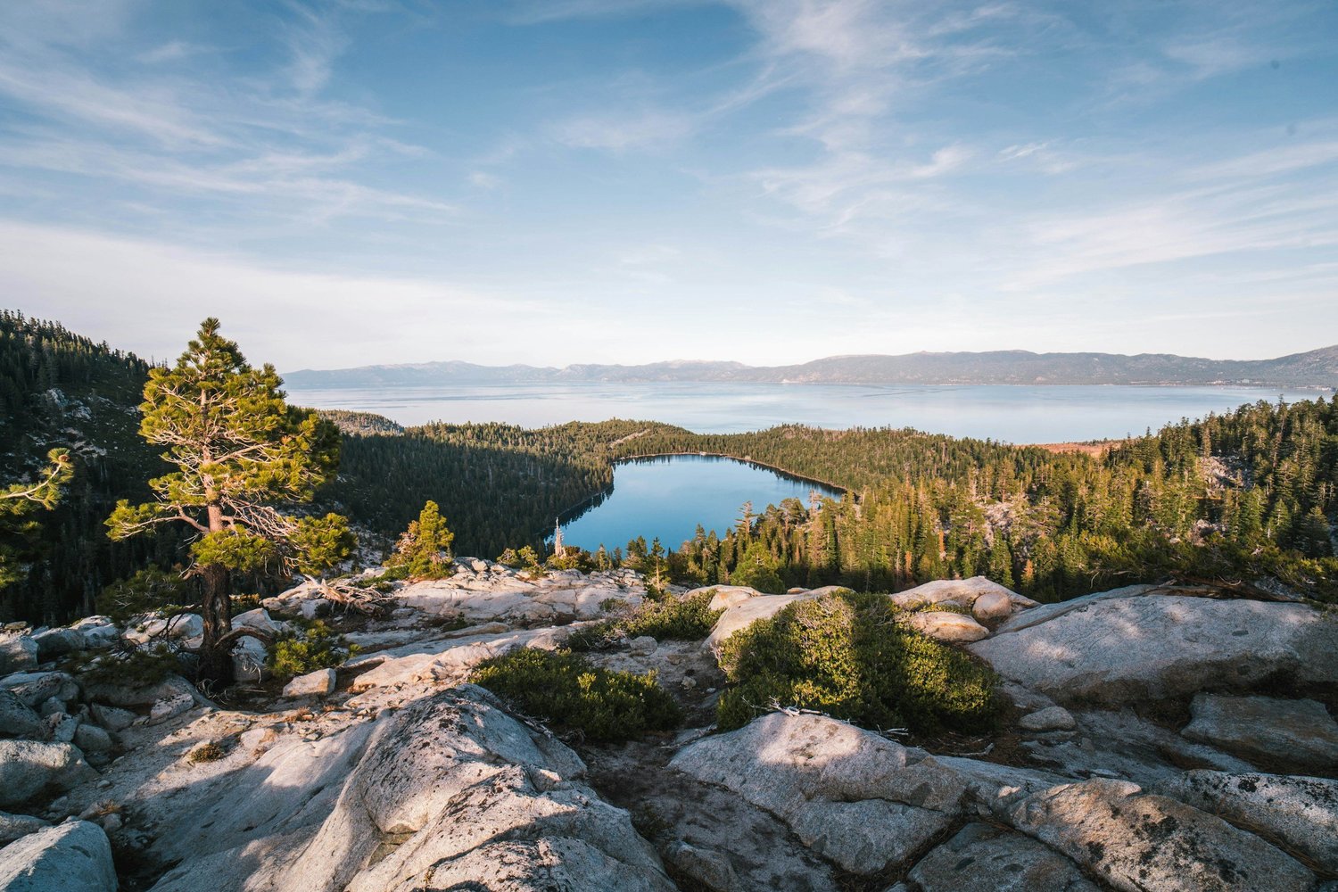 Lake Tahoe and a quiet lake surrounded by pine trees